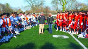 Representatives from the Lead the Way Foundation address the Manhasset Indians (left) and Chaminade Flyers (right) before they face off.