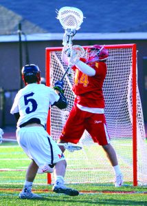 Chaminade goalie Jack Zullo makes a save on Indians forward Ronan Garcia