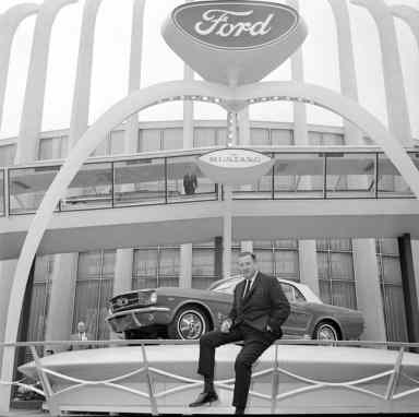 Henry Ford II poses with the all-new Mustang