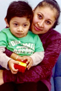  A mother works with her son to prepare him for preschool, under the guidance of specialists from the Nassau BOCES Parent-Child Home Program.