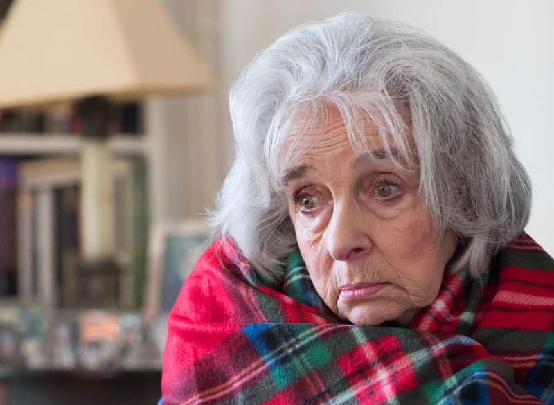 Senior Woman Wrapped In Blanket Unable To Afford Heating Bills