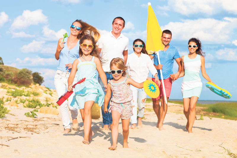 Multiracial group of friends walking at the beach