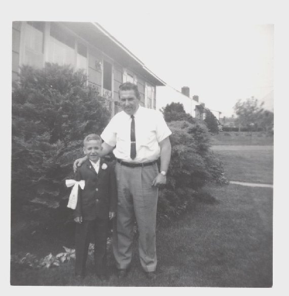 Dennis with his father, celebrating his first communion.