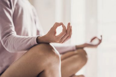 Woman meditating at home. Girl practicing yoga in yoga class