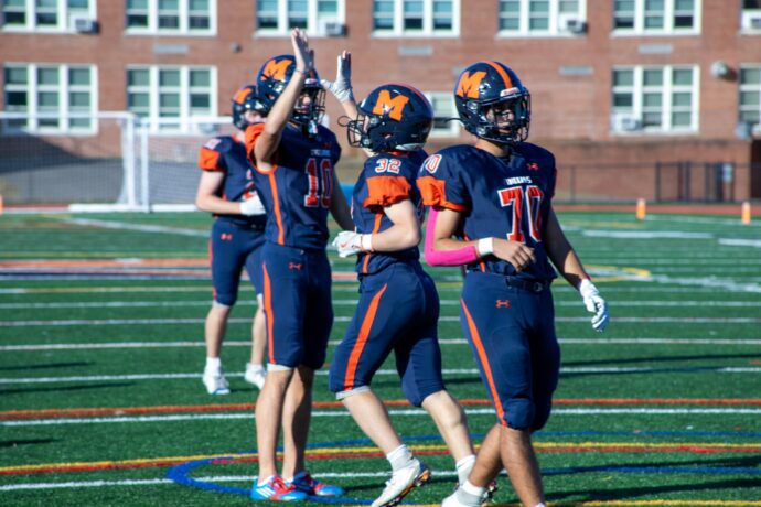 7 Manhasset Homecoming more Set celebrating as they expand their lead over Mineola 690x460 1