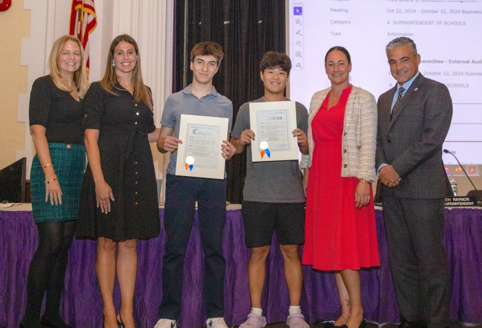 Adrian Kim and Brandon Antonetti, National Merit Semifinalists, accept citations from the county