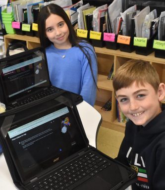 Forest Lake Elementary School fifth graders, from left, Hugh McQuillan, Toni Pagano and Vincent Kennedy have found many benefits to using AI as a learning tool.