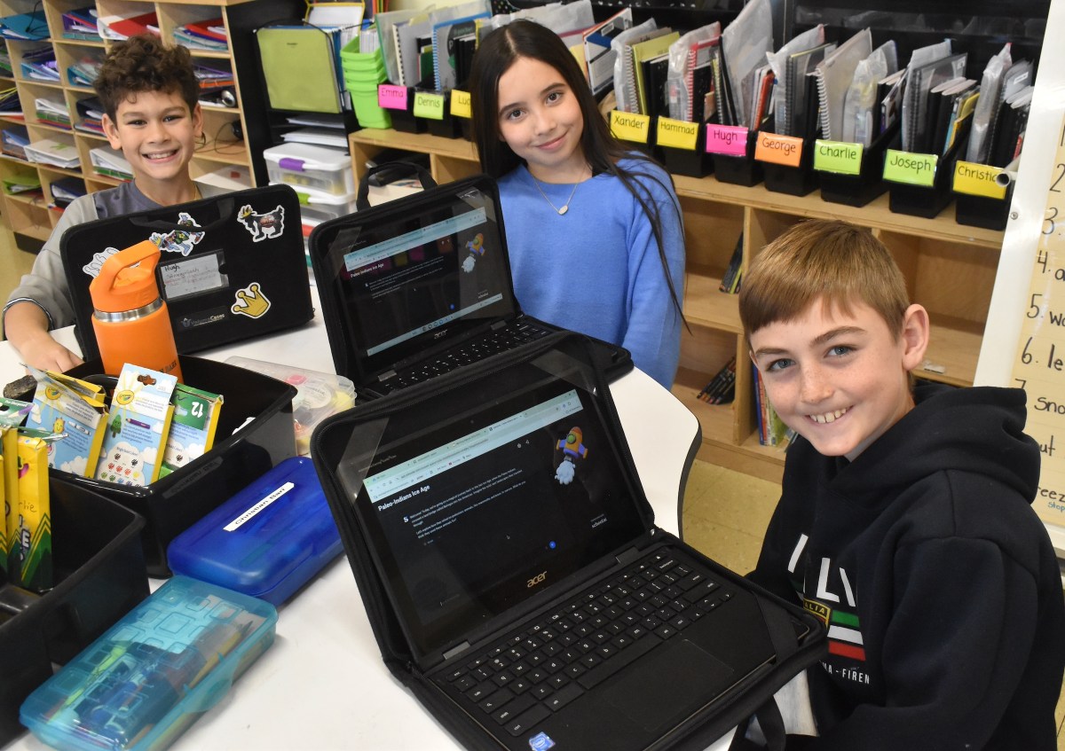 Forest Lake Elementary School fifth graders, from left, Hugh McQuillan, Toni Pagano and Vincent Kennedy have found many benefits to using AI as a learning tool.