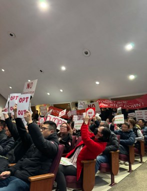 The Syosset community brings "Opt Out" signs to the Dec. 9 board meeting while discussing regionalization