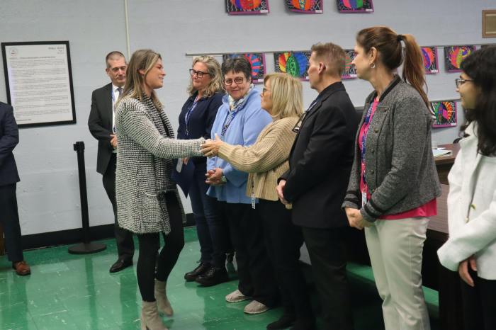 Abbey Lane Elementary School teacher Kelly McAuley lent vital aid to a student who began choking. She was recognized for her quick action at the Dec. 4 Levittown Board of Education meeting, where she shook hands with trustees, including Peggy Marenghi.