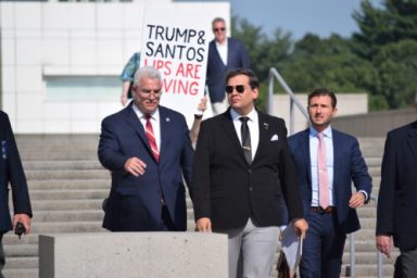 Ex-Rep. George Santos (right) leaving the U.S. District Court in Central Islip with his attorney Joseph Murray (left)