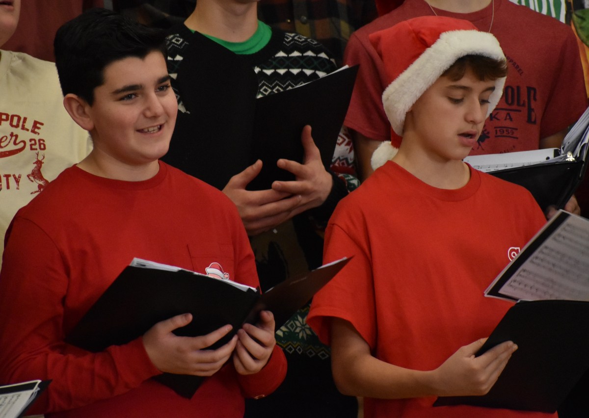 Vocal Points members Matthew Fanelli, left, and Charlie Celona helped spread holiday cheer.