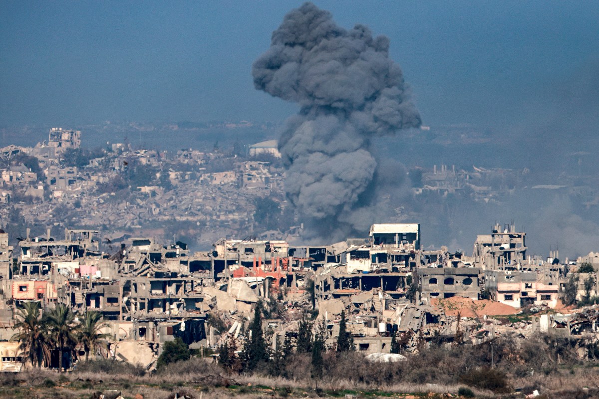 This picture taken from the Israeli side of the border with the Gaza Strip shows a smoke plume rising from explosions above destroyed buildings in the northern Gaza Strip on January 13, 2025 amid the ongoing war between Israel and Hamas.