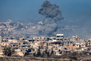 This picture taken from the Israeli side of the border with the Gaza Strip shows a smoke plume rising from explosions above destroyed buildings in the northern Gaza Strip on January 13, 2025 amid the ongoing war between Israel and Hamas.