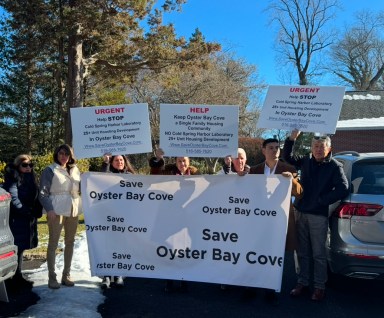 Oyster Bay Cove residents rally against a proposed 28-unit apartment building on Sandy Hill Road