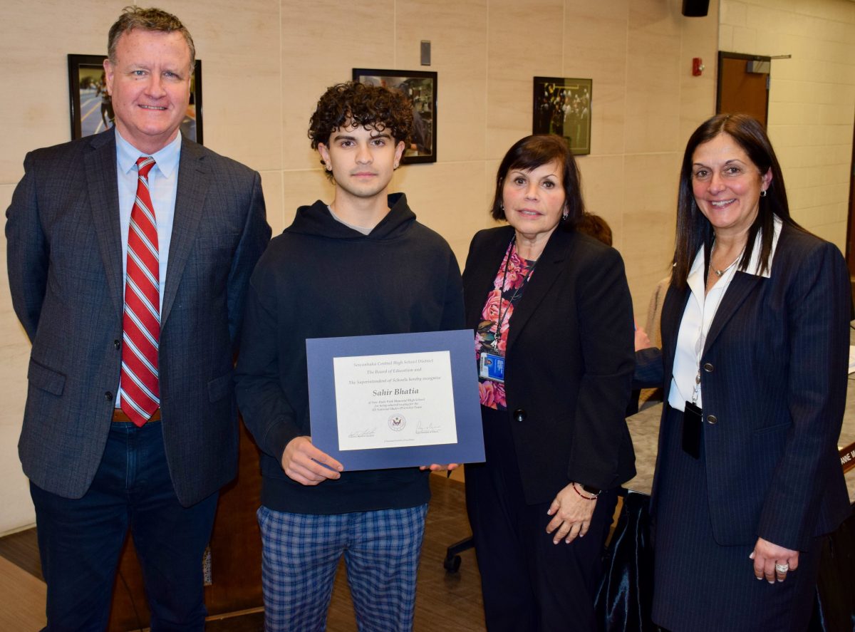 New Hyde Park Memorial High School senior Sahir Bhatia is pictured with, from left, board President William Leder, Principal Rosemary DeGennaro and Superintendent Regina Agrusa at the board of education meeting on Jan. 28.