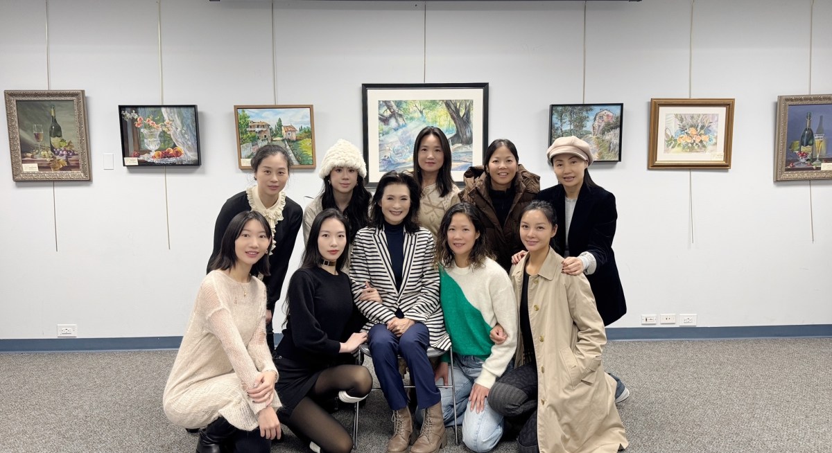 10 of the exhibit's artists from Syosset and Jericho stand in front of their work at the Jericho library