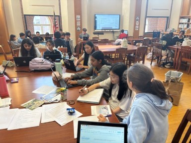 Manhasset Secondary School students at work on the 2024 issue of “The Phoenix,” which was recently recognized as a REALM First Class magazine by the National Council of Teachers of English