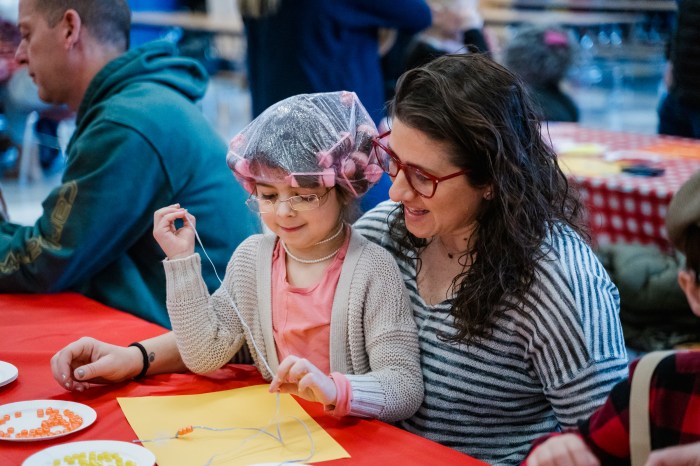 Following the parade, students teamed up with their special guests to create necklaces out of 100 beads.