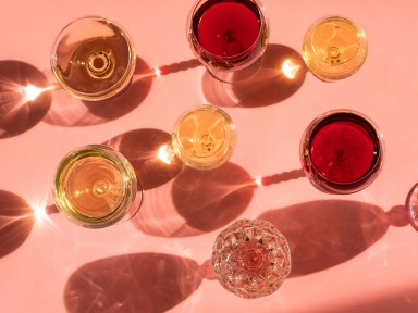 wine glasses on a pink background in the sunlight