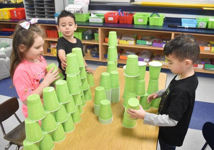 Kindergartners Harley Langer, Logan Thompson and Peter Scotti, right