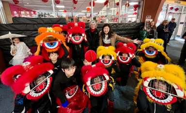 Children partake in a traditional lion dance for Lunar New Year