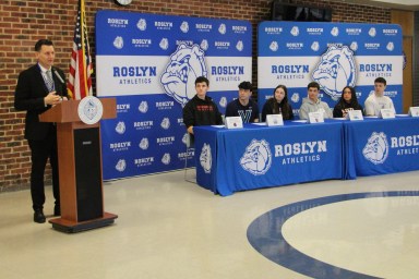 Student athletes at Roslyn High School commit to their college's sports teams