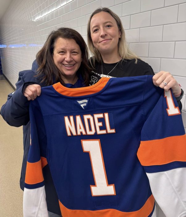 Town of North Hempstead Council Member Mariann Dalimonte poses with the New York Islanders' Community Hero of the Month, Emma Nadel, for her work in the community's volunteer fire house and police force.