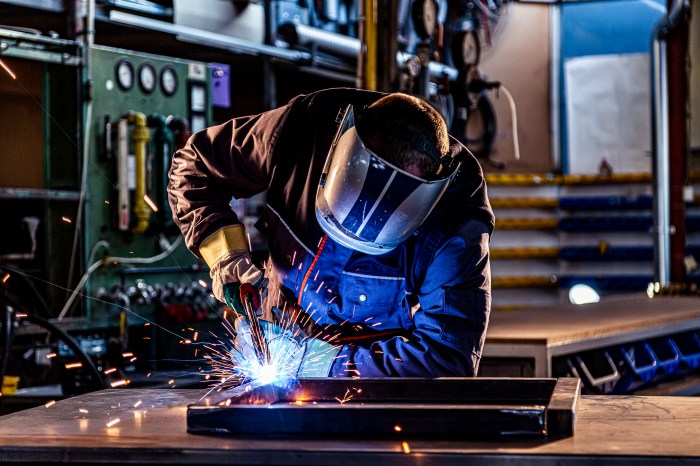 Industrial worker welding at the factory