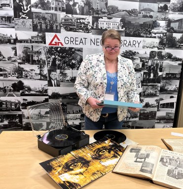 Great Neck Library reference librarian and local history custodian Christy Orquera listens to 1920s music and reviews time period archives in preparation for the upcoming April celebration