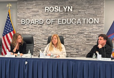 Roslyn Board of Education President Meryl Ben-Levy discusses decreaes in state aid with members of the board of education.