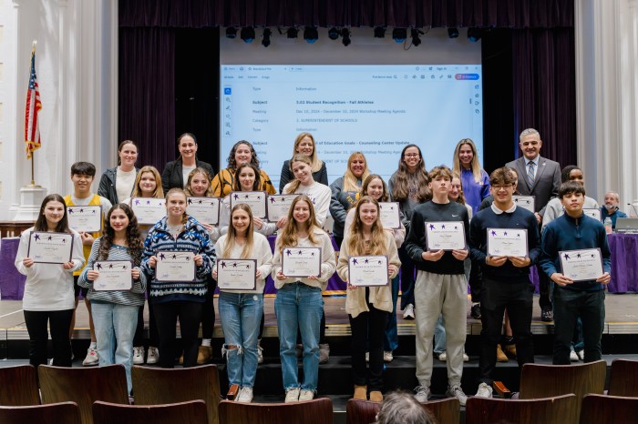 The Oyster Bay-East Norwich Board of Education with students from the districts nine fall season athletics teams