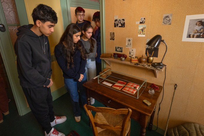 Students of Great Neck North High School standing in the full scale recreation of the annex where Anne Frank wrote her diary