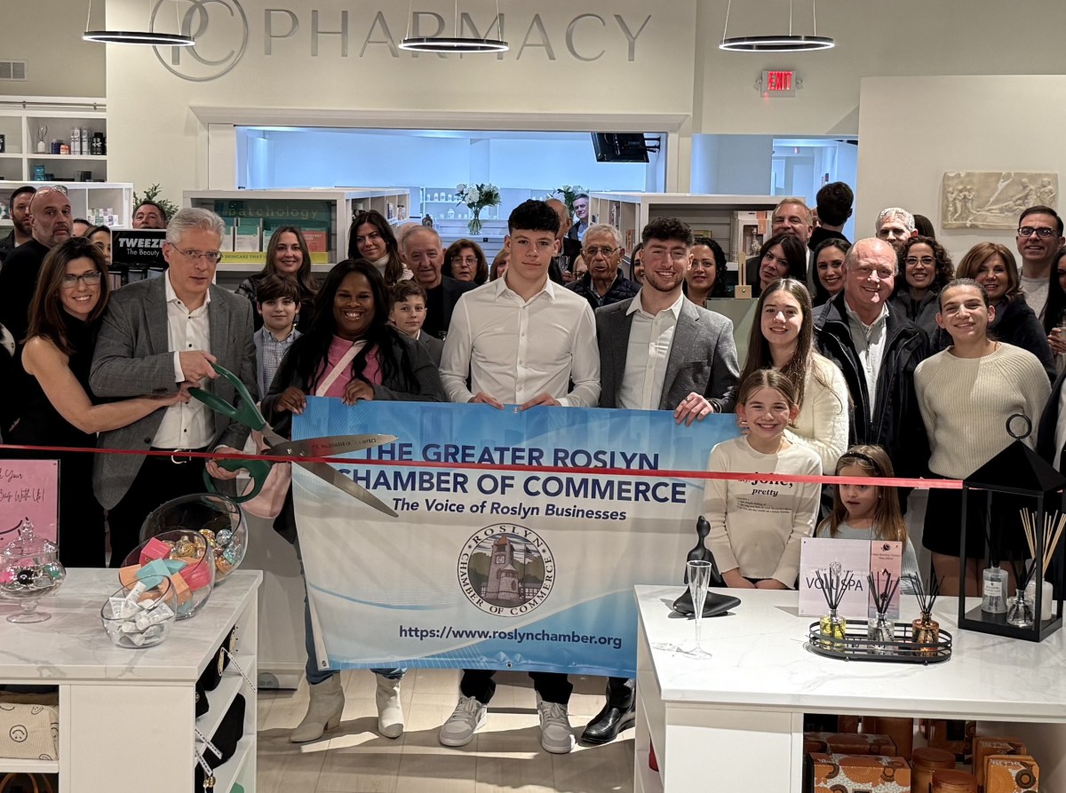 Owner Tom Amigdalos joins with friends, family and the Roslyn Chamber of Commerce to open PureCare Pharmacy & Wellness on Tuesday, March 4.