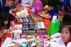 Children compete together at the Champskids artys competition on Saturday night at the Children's Museum.